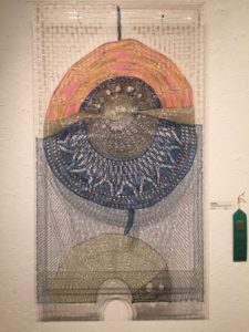 "Mercury Rising by Pam Moore. Knitted lace mounted on plexiglass frame. Honorable Mention.